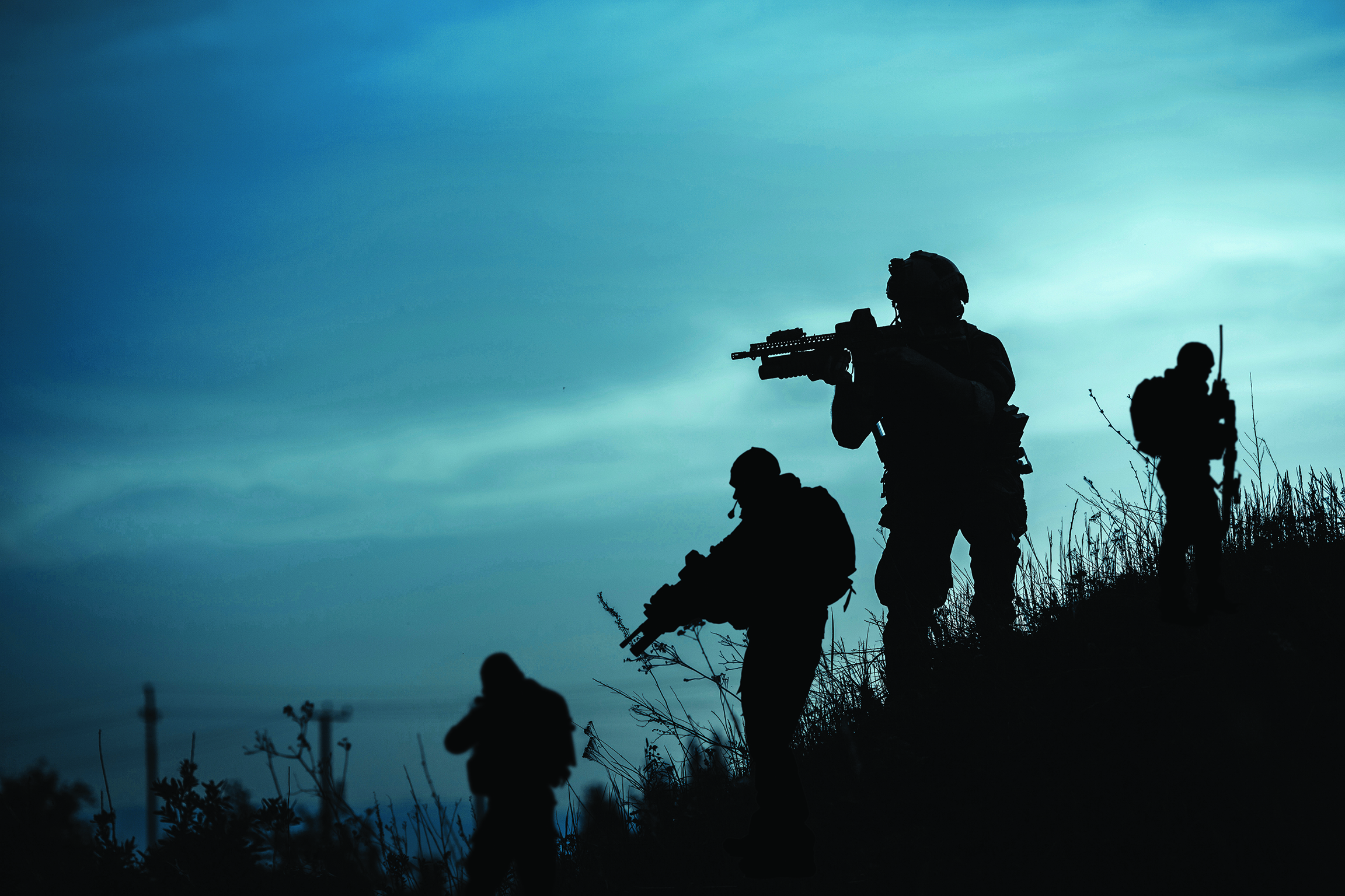 Armed soldiers at night